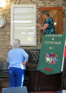 Lis Davies and Mary Venn before last night's meeting,  making sure our banner cabinet is sparkly and clean.