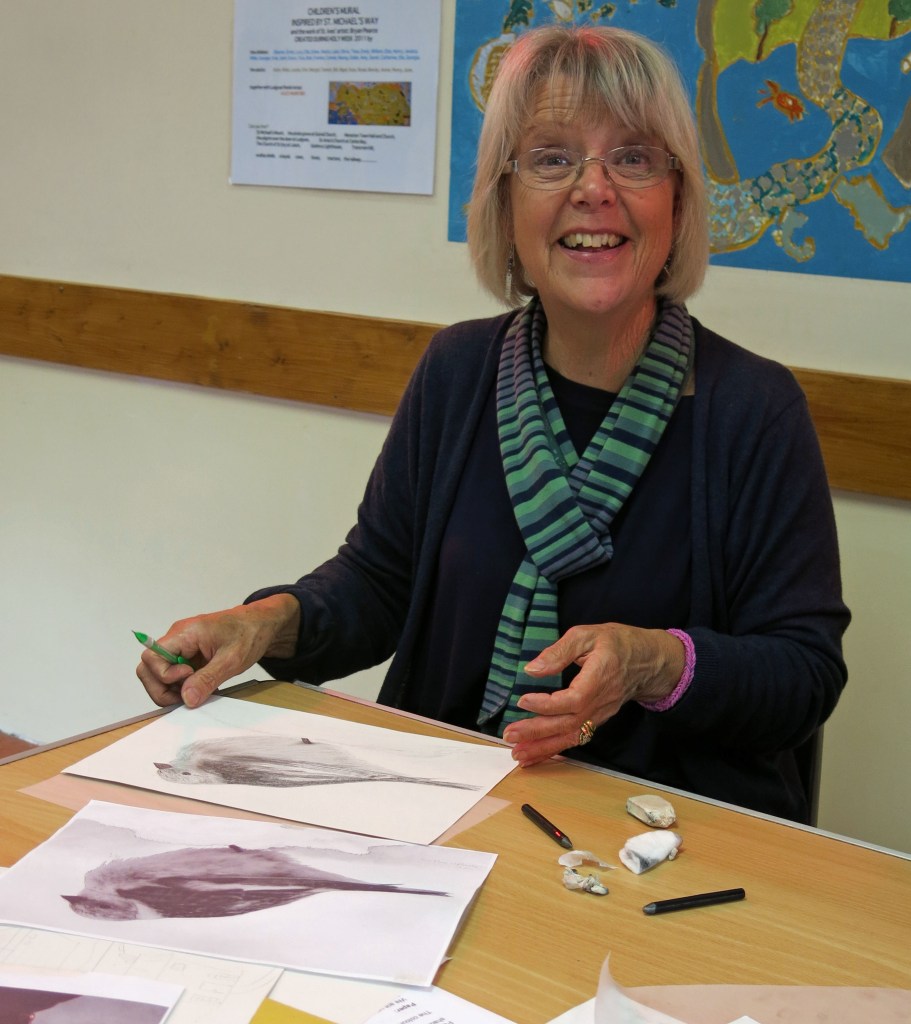 Lis is all smiles while working on her bird drawing.