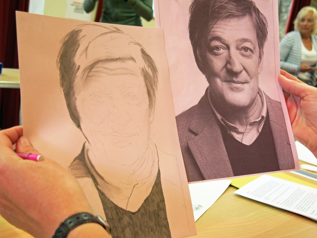 Alison works on a drawing of Stephen Fry.