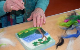Val puts some final touches on her lovely piece of needle felting
